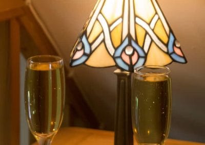 Lamp and welcome drinks inside The Thatched Cottage